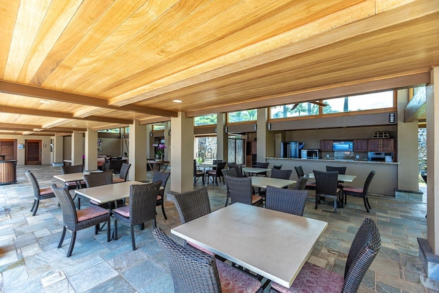 dining space with beamed ceiling and wood ceiling