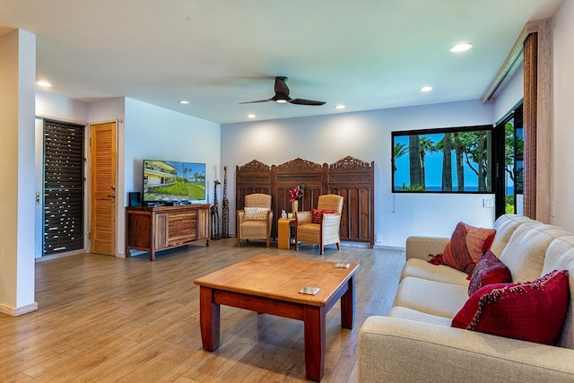 living room with ceiling fan and hardwood / wood-style floors