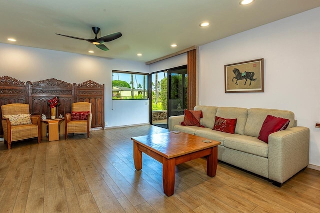 living room with light hardwood / wood-style floors and ceiling fan