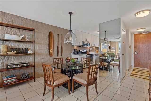 dining area featuring light tile flooring