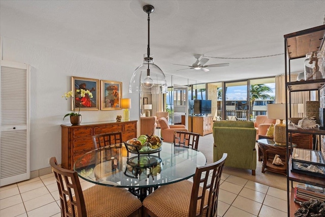 dining room with light tile floors, ceiling fan, and a textured ceiling