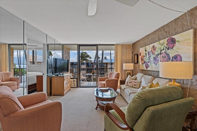 carpeted living room featuring a wall of windows and ceiling fan