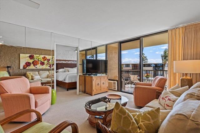 carpeted living room with floor to ceiling windows and ceiling fan