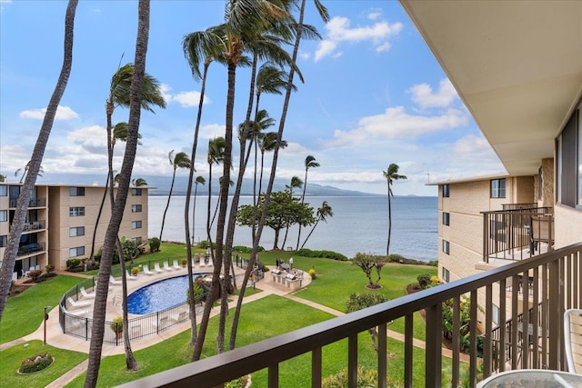 exterior space with a water view and a community pool