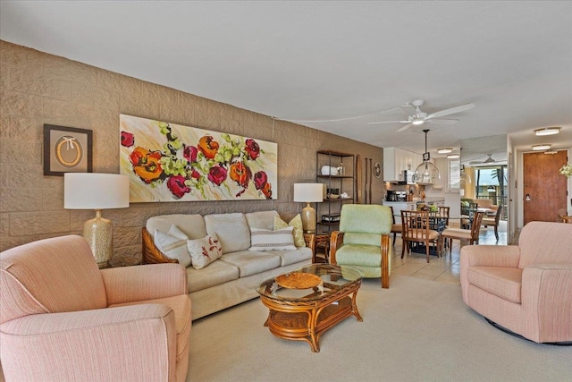 carpeted living room featuring ceiling fan