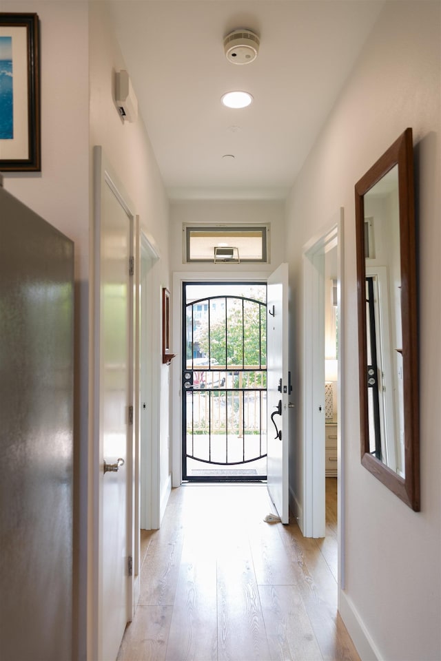 entryway with baseboards and light wood-type flooring