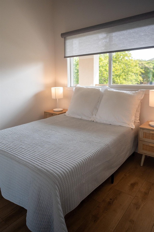 bedroom with hardwood / wood-style flooring