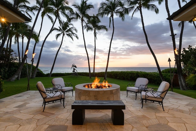 view of patio / terrace with a water view and a fire pit