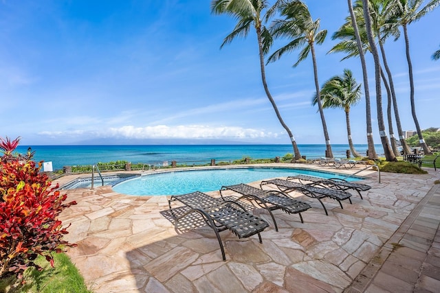 view of swimming pool with a water view