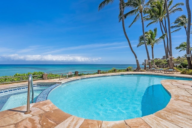 view of pool featuring an in ground hot tub and a water view