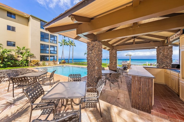 view of swimming pool featuring a gazebo, a patio, and a water view