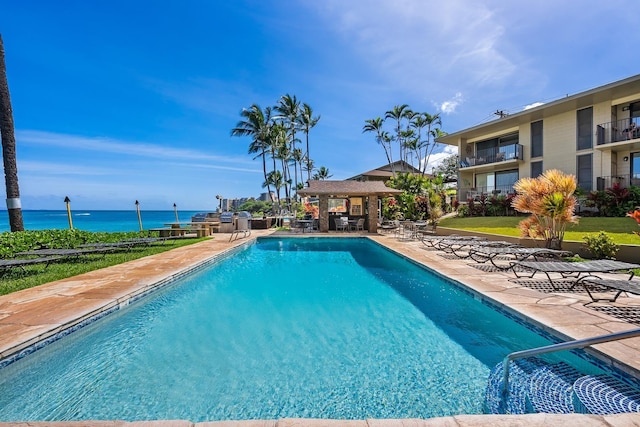 view of swimming pool featuring a water view