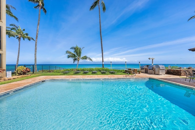 view of swimming pool featuring a patio and a water view