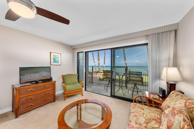 carpeted living room with ceiling fan