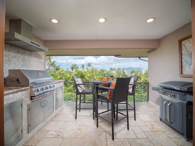 view of patio / terrace featuring a mountain view, area for grilling, and a grill