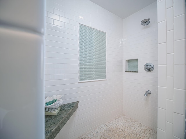 bathroom with a tile shower