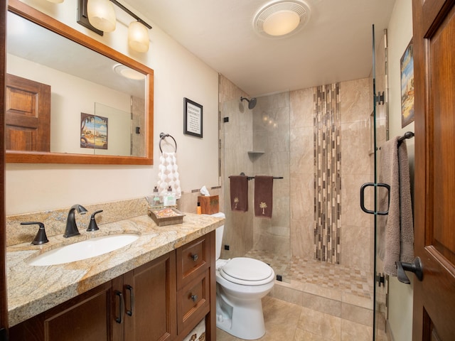 bathroom with vanity, toilet, tile patterned floors, and walk in shower