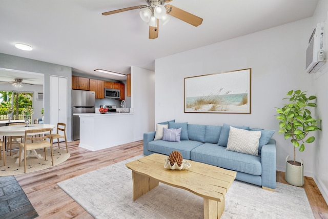 480 Kenolio Rd Unit 22-105, Kihei, HI 96753 - living area with ceiling fan and light wood-type flooring