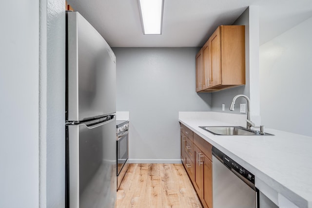 480 Kenolio Rd Unit 22-105, Kihei, HI 96753 - kitchen with appliances with stainless steel finishes, light wood-style floors, and light countertops