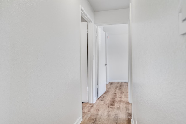480 Kenolio Rd Unit 22-105, Kihei, HI 96753 - corridor with light wood-style flooring and baseboards