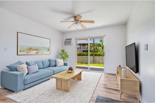 480 Kenolio Rd Unit 22-105, Kihei, HI 96753 - living room with a wall mounted AC, a ceiling fan, and wood finished floors