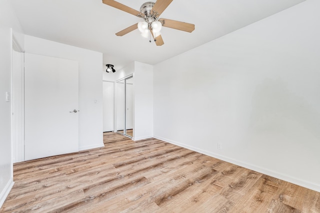 480 Kenolio Rd Unit 22-105, Kihei, HI 96753 - unfurnished bedroom featuring wood finished floors, ceiling fan, and a closet