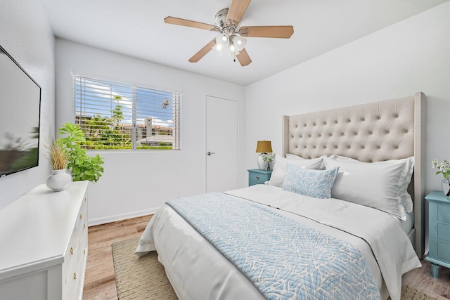 480 Kenolio Rd Unit 22-105, Kihei, HI 96753 - bedroom with light wood-style floors and ceiling fan