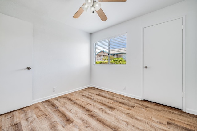 480 Kenolio Rd Unit 22-105, Kihei, HI 96753 - unfurnished bedroom with wood finished floors and ceiling fan