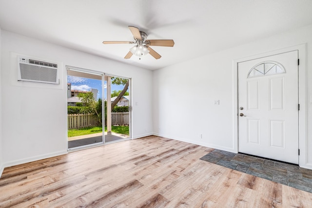 480 Kenolio Rd Unit 22-105, Kihei, HI 96753 - entryway with a wall mounted air conditioner, ceiling fan, and wood finished floors