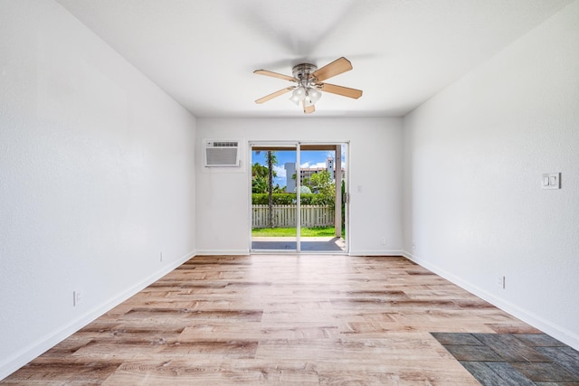 480 Kenolio Rd Unit 22-105, Kihei, HI 96753 - unfurnished room with a wall mounted AC, ceiling fan, and wood finished floors