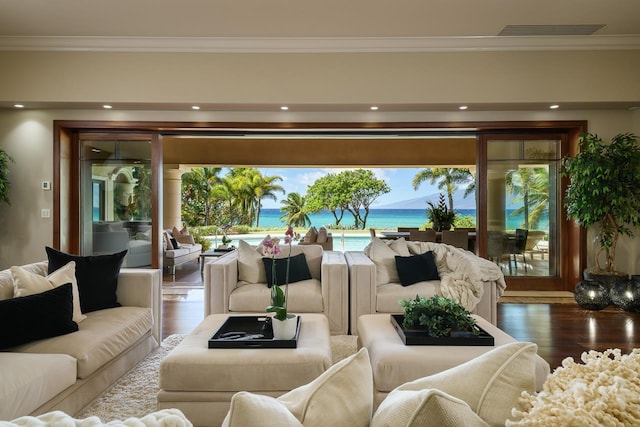 living room with a water view, ornamental molding, and hardwood / wood-style flooring