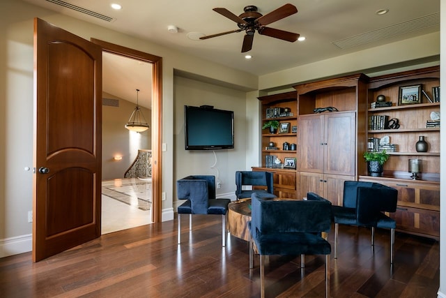 home office with lofted ceiling, ceiling fan, and dark hardwood / wood-style flooring