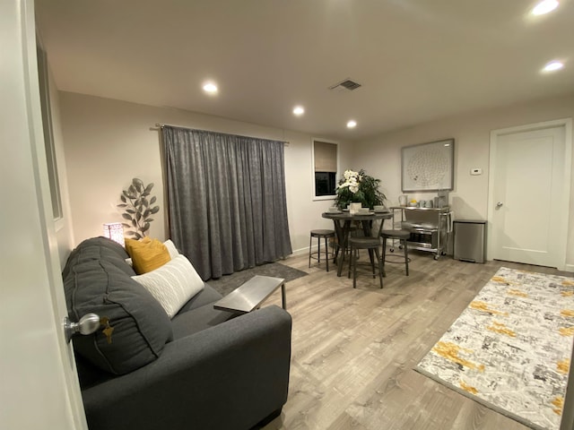 living room with light hardwood / wood-style flooring