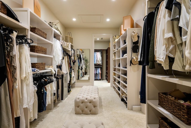 spacious closet featuring light carpet