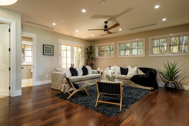 living room with dark hardwood / wood-style flooring and ceiling fan