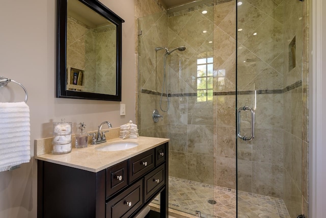 bathroom with vanity and a shower with shower door