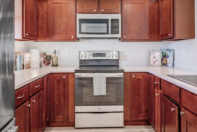 kitchen with appliances with stainless steel finishes and light wood-type flooring