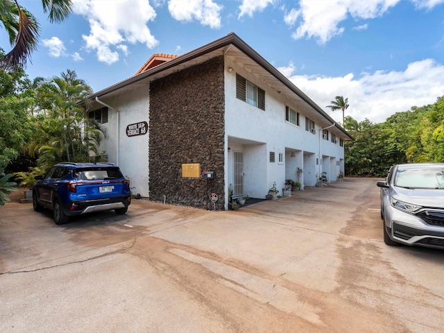 68 Walaka St Unit 5, Kihei, HI 96753 - view of home's exterior featuring stucco siding, stone siding, and a tile roof