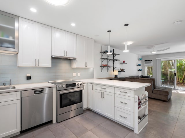 68 Walaka St Unit 5, Kihei, HI 96753 - kitchen featuring stainless steel appliances, a peninsula, light countertops, open floor plan, and white cabinets