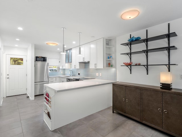 68 Walaka St Unit 5, Kihei, HI 96753 - kitchen with open shelves, stainless steel appliances, white cabinetry, a peninsula, and decorative backsplash