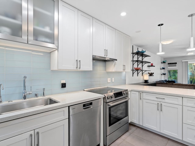 68 Walaka St Unit 5, Kihei, HI 96753 - kitchen featuring appliances with stainless steel finishes, white cabinets, decorative backsplash, and light countertops