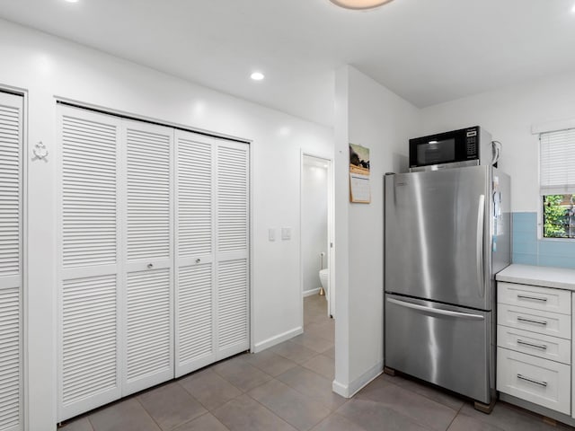 68 Walaka St Unit 5, Kihei, HI 96753 - kitchen with stainless steel appliances, light countertops, white cabinets, light tile patterned floors, and recessed lighting