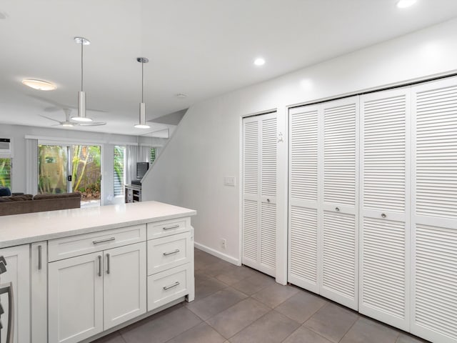 68 Walaka St Unit 5, Kihei, HI 96753 - kitchen with a ceiling fan, hanging light fixtures, light countertops, white cabinetry, and open floor plan