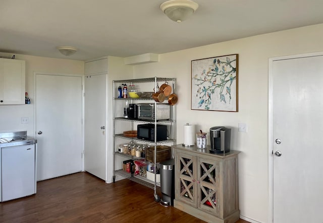 kitchen with white cabinetry, washer / dryer, white range with electric cooktop, and dark hardwood / wood-style floors