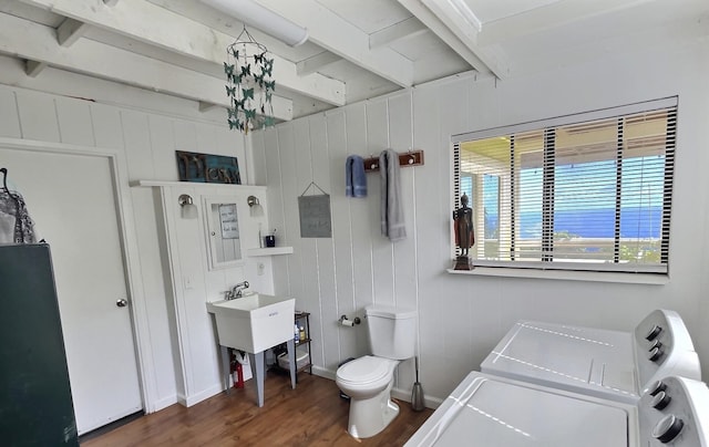 bathroom with toilet, beam ceiling, wood walls, and hardwood / wood-style flooring