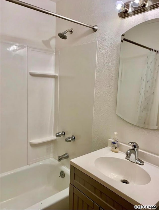 bathroom featuring vanity and shower / tub combo with curtain