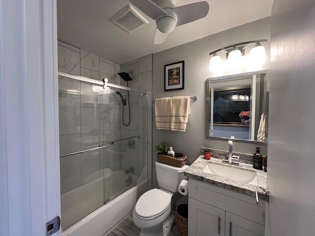 15 Kulanihakoi St Unit 9E, Kihei, HI 96753 - full bathroom with vanity, toilet, ceiling fan, and enclosed tub / shower combo