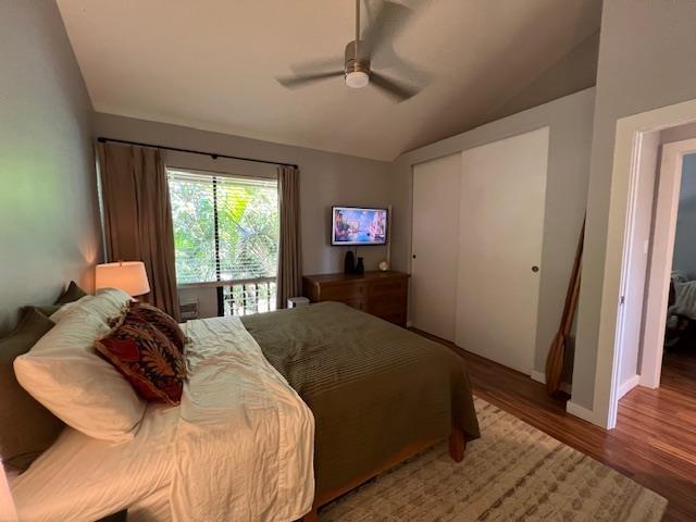 15 Kulanihakoi St Unit 9E, Kihei, HI 96753 - bedroom with lofted ceiling, wood finished floors, a closet, baseboards, and ceiling fan
