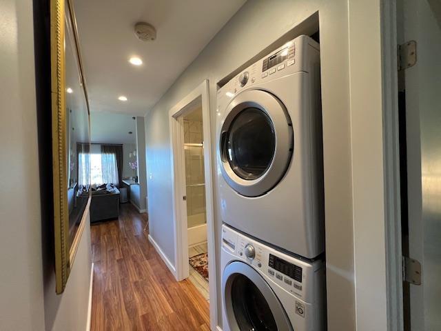 15 Kulanihakoi St Unit 9E, Kihei, HI 96753 - laundry room with estacked washer and dryer, wood finished floors, recessed lighting, and baseboards