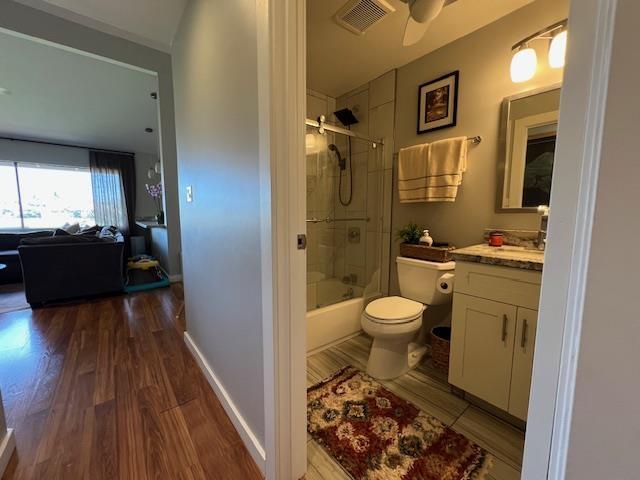 15 Kulanihakoi St Unit 9E, Kihei, HI 96753 - full bath featuring vanity, toilet, wood finished floors, combined bath / shower with glass door, and ceiling fan